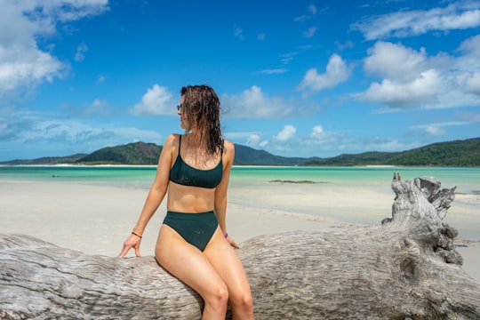 woman in green bikini standing on beach during daytime in Whitsunday Islands National Park Australia