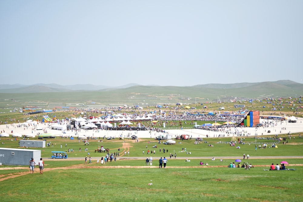 people on green grass field during daytime