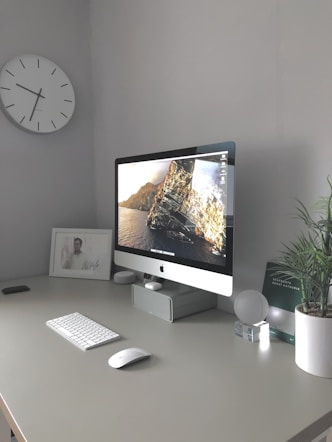 silver imac on white table
