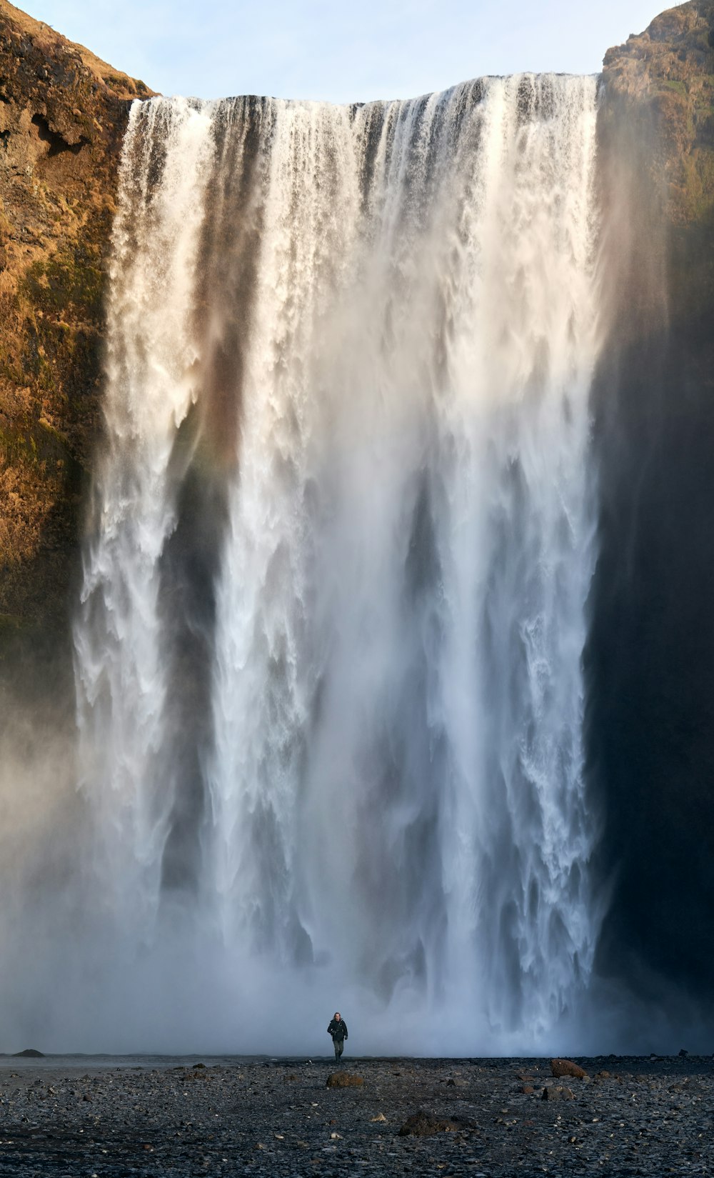 water falls on brown field