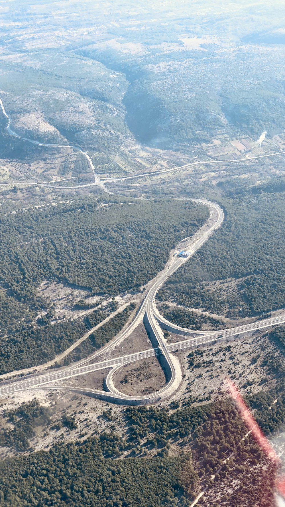 aerial view of road in the middle of mountains