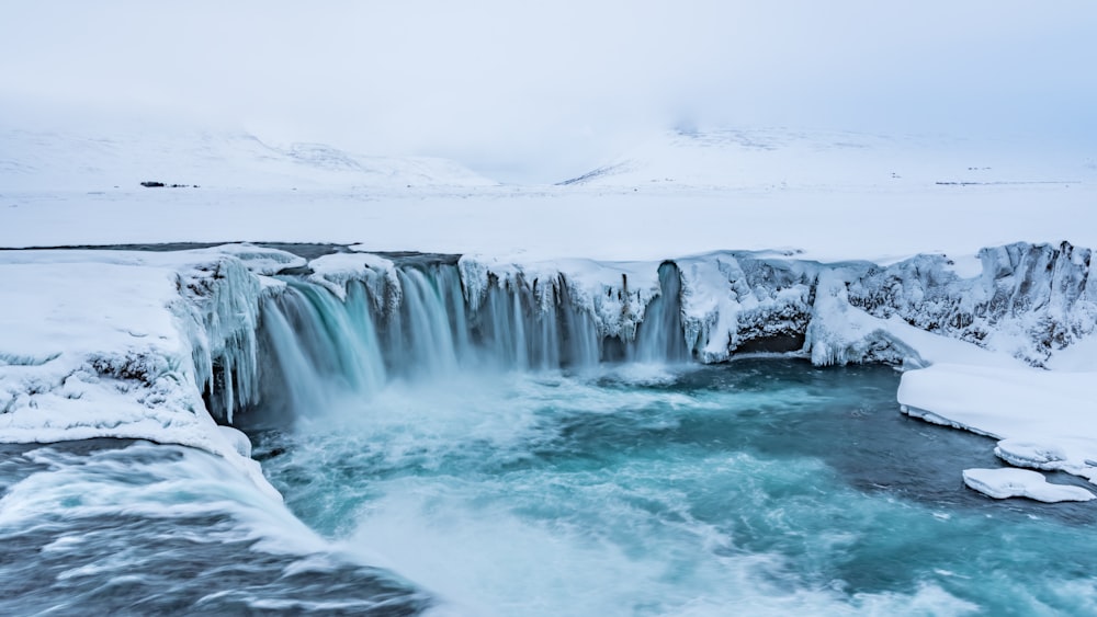 water falls under white sky during daytime