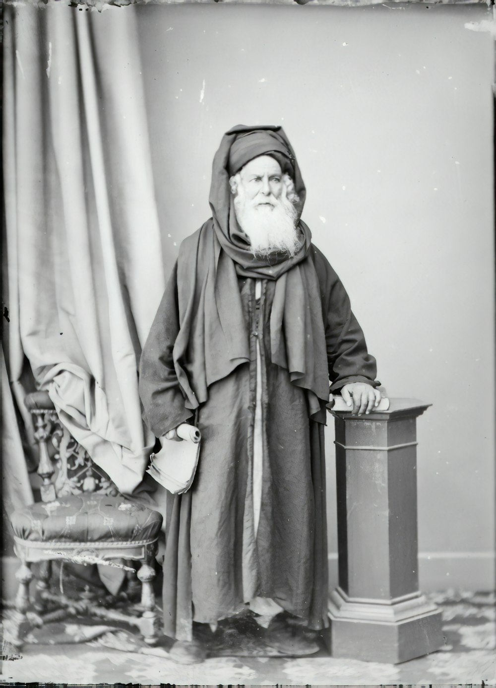 man in black coat sitting on chair