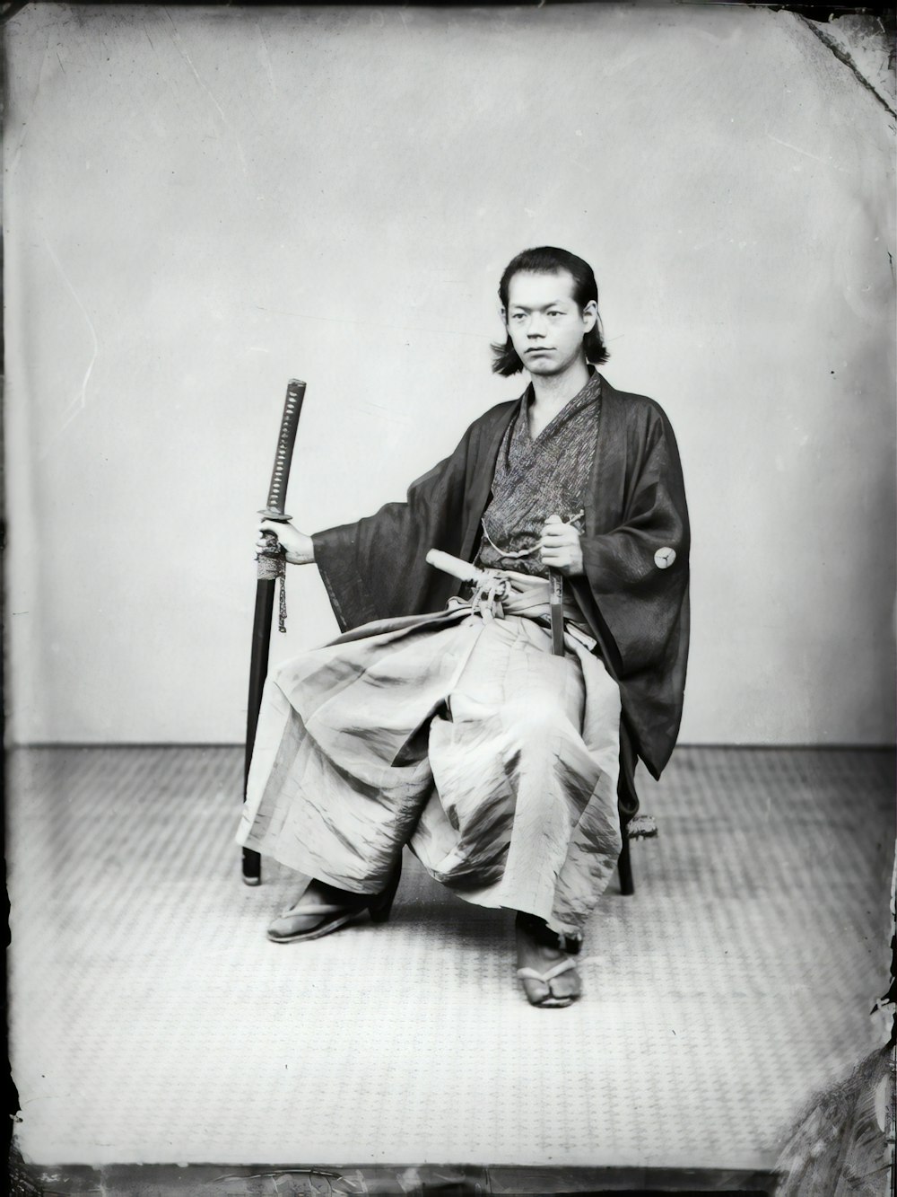 man in black coat and pants sitting on chair