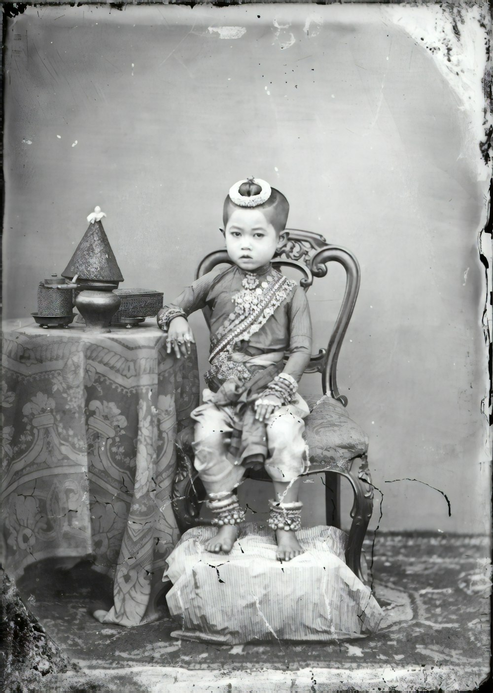 grayscale photo of 2 children sitting on chair