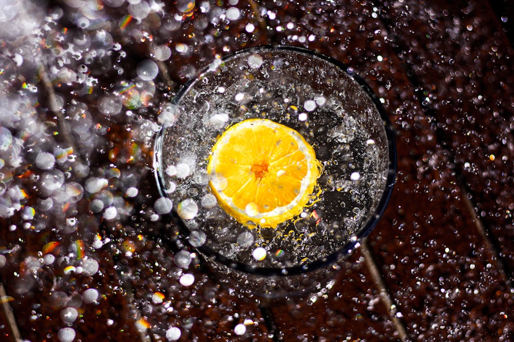 sliced lemon on clear drinking glass