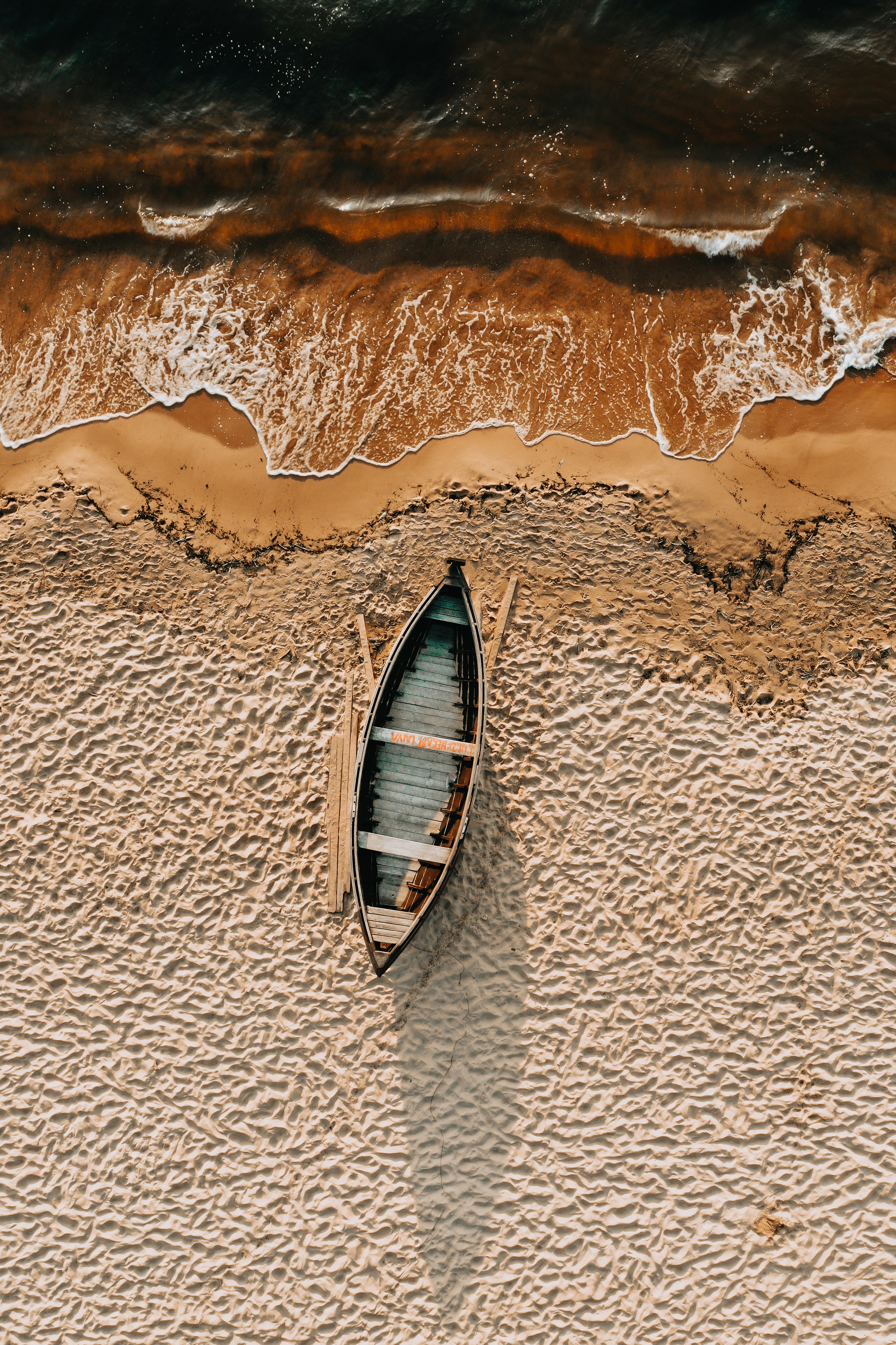 brown and white boat on brown sand