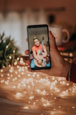 A musician interacting with fans on a smartphone, showcasing social media engagement.