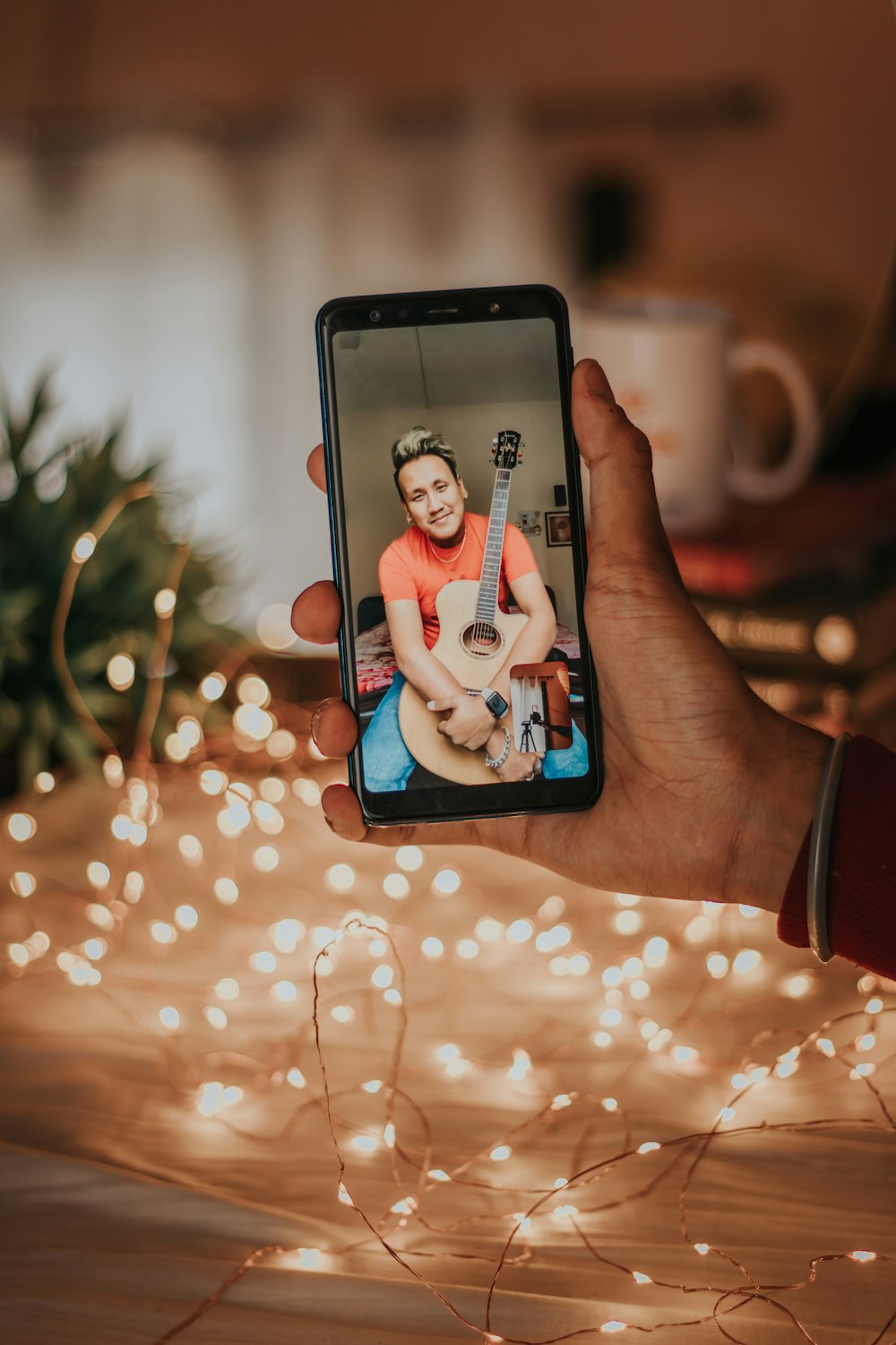 person holding iphone with woman in blue shirt