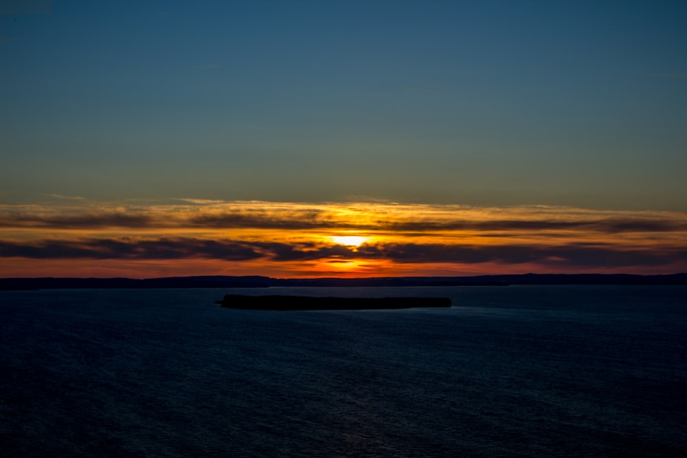 body of water during sunset