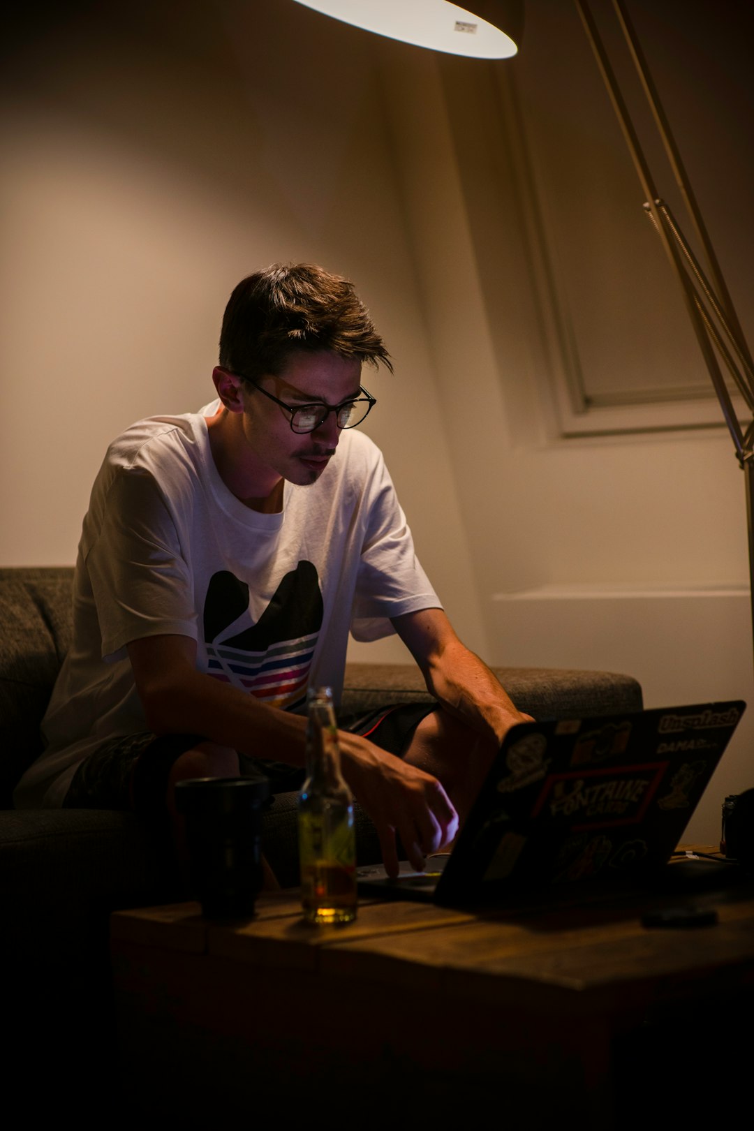 man in white crew neck t-shirt sitting on couch