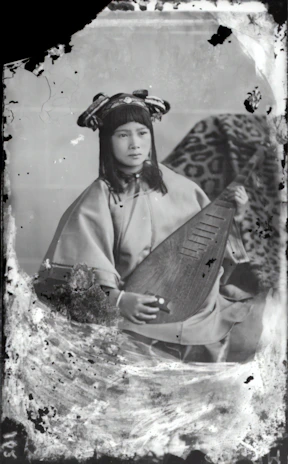 Portrait of a local artist in Shashamane holding a traditional string instrument, smiling warmly.