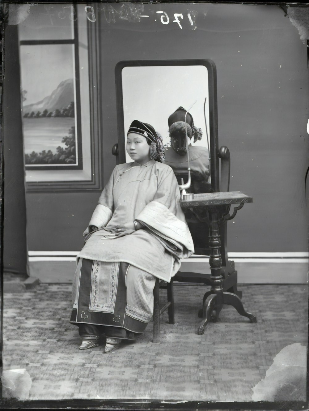 grayscale photo of woman sitting on chair