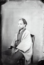 A candid portrait of a local Southeast Asian person in natural street surroundings.