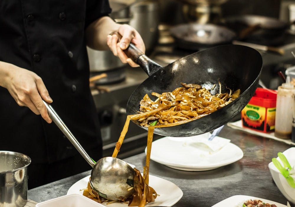 person holding silver spoon and fork