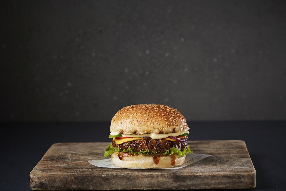 burger on brown wooden chopping board