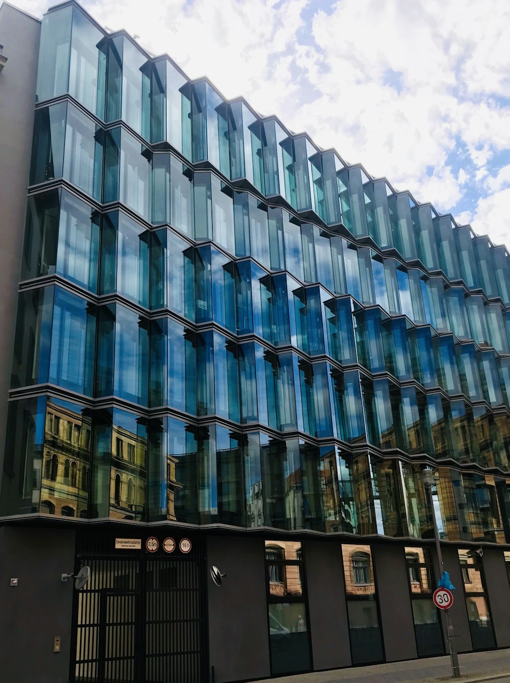 blue and white concrete building under blue sky during daytime