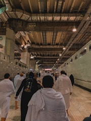 Group of hospital staff wearing crisp, clean white uniforms in a bright corridor.