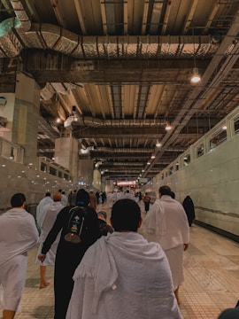 Group of hospital staff wearing crisp, clean white uniforms in a bright corridor.
