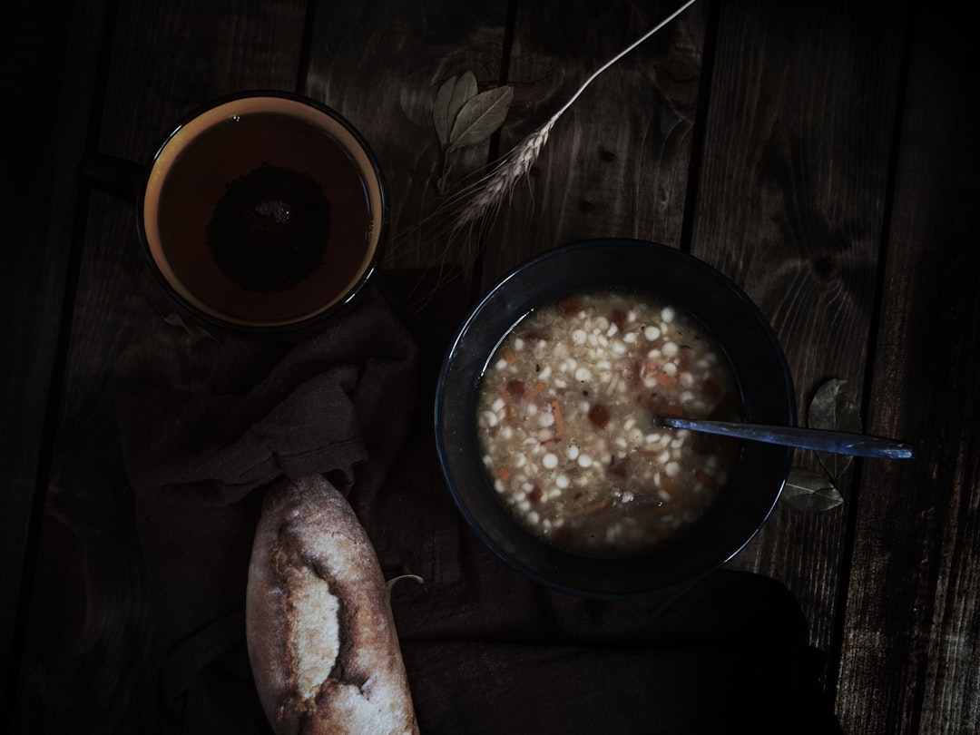 black ceramic bowl with rice and spoon