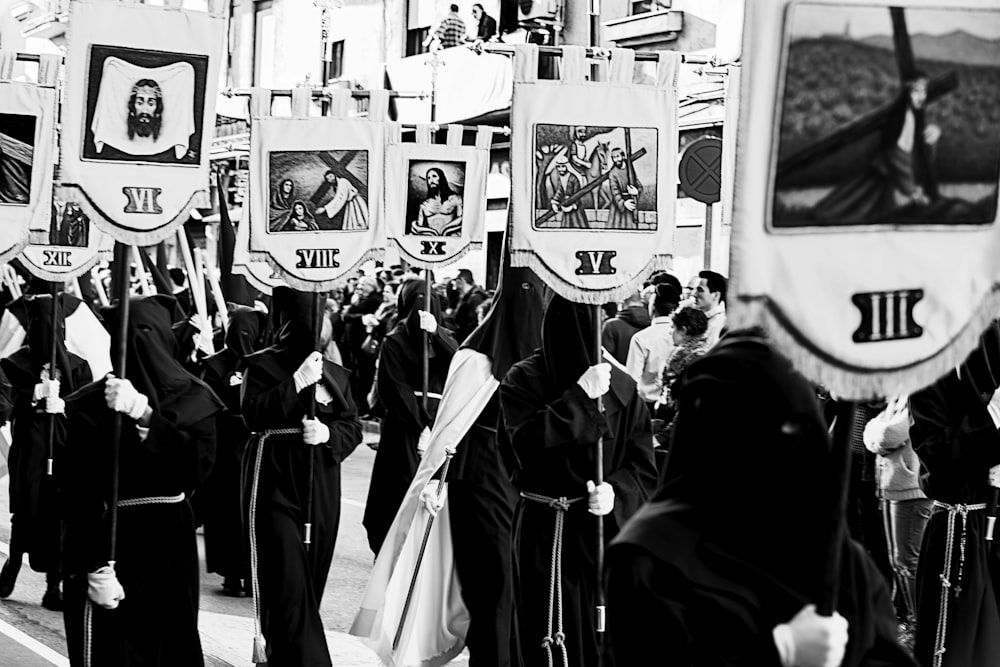 personnes en robe noire debout devant un mur blanc et noir