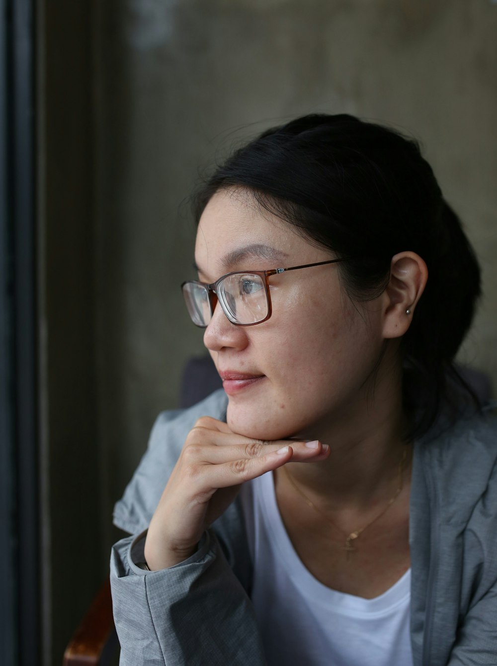 woman in blue shirt wearing eyeglasses