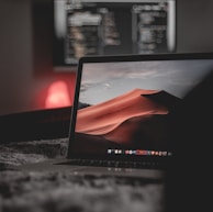 black laptop computer on brown marble table