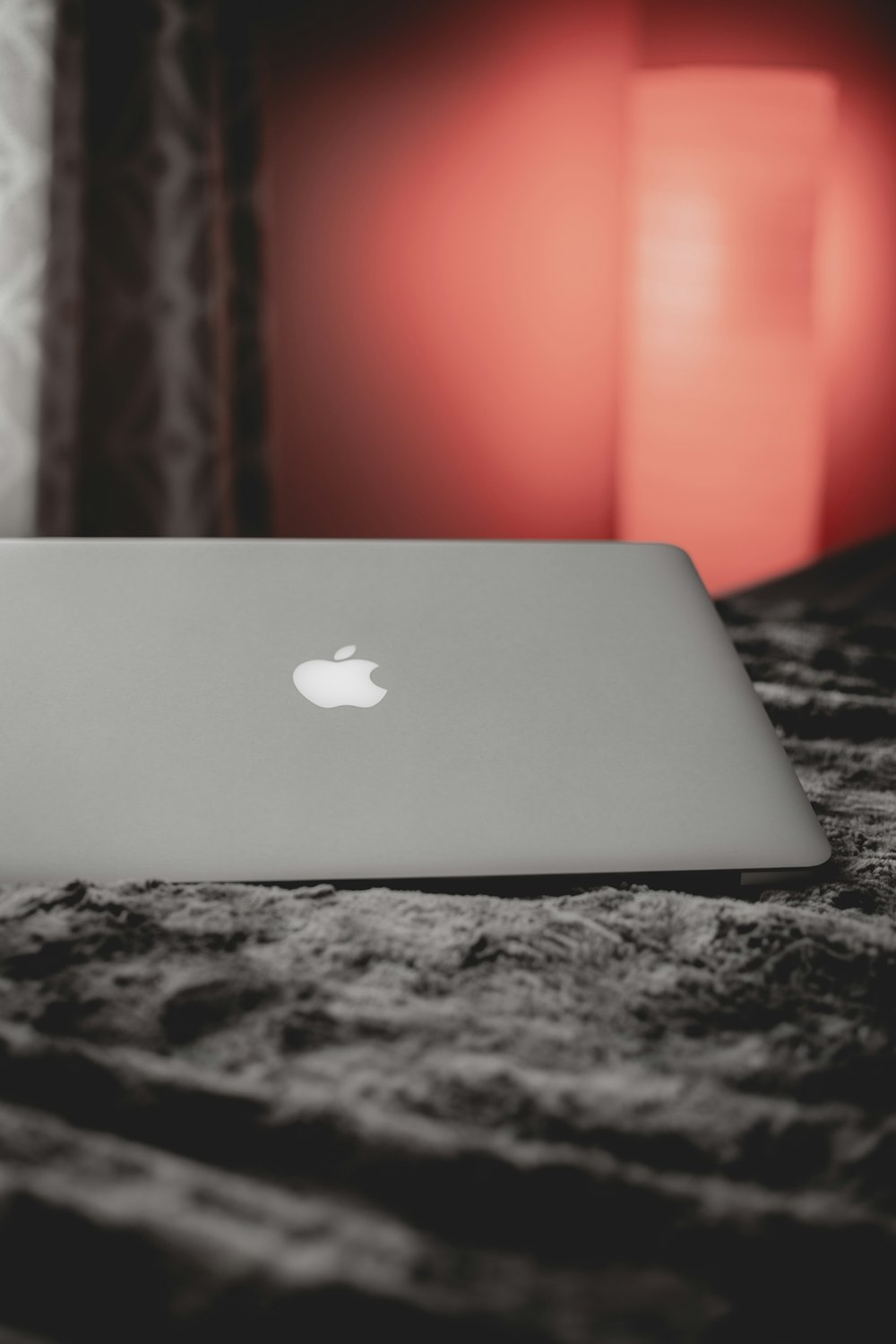 silver macbook on black and white marble table