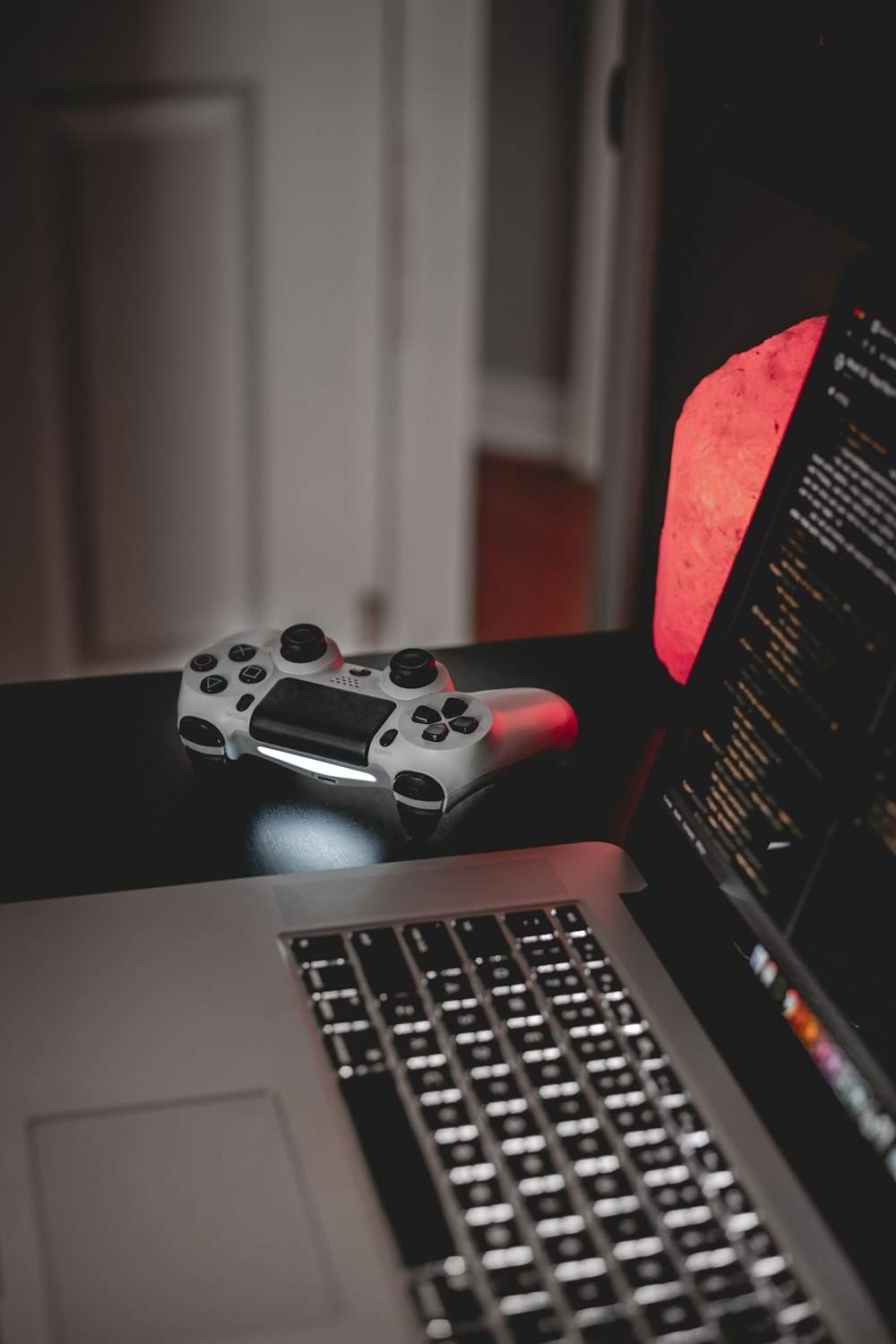 white and black game controller on macbook pro