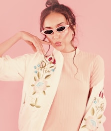 woman in white and red floral long sleeve shirt wearing sunglasses