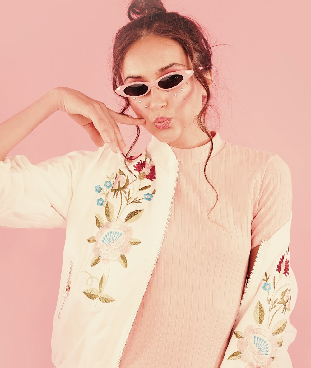 woman in white and red floral long sleeve shirt wearing sunglasses