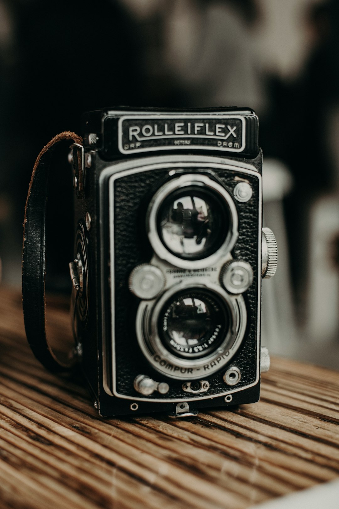 black and silver dslr camera on brown wooden table