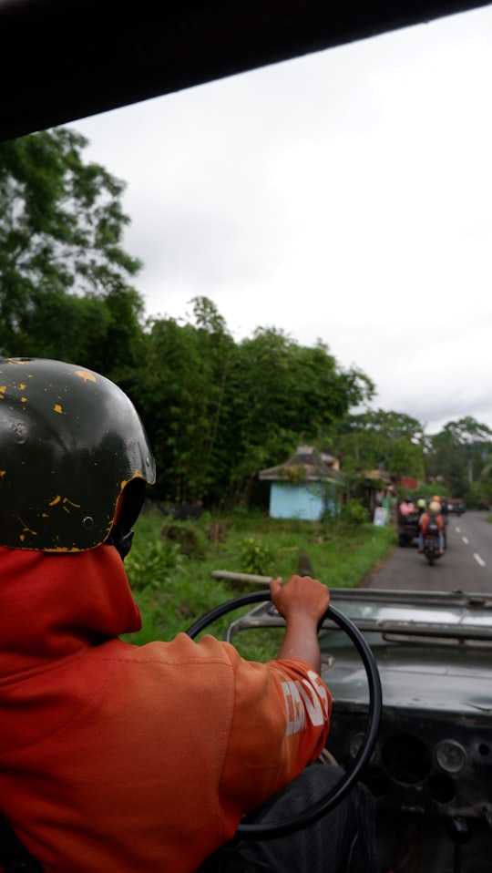 man in orange jacket wearing black helmet in Yogyakarta City Indonesia