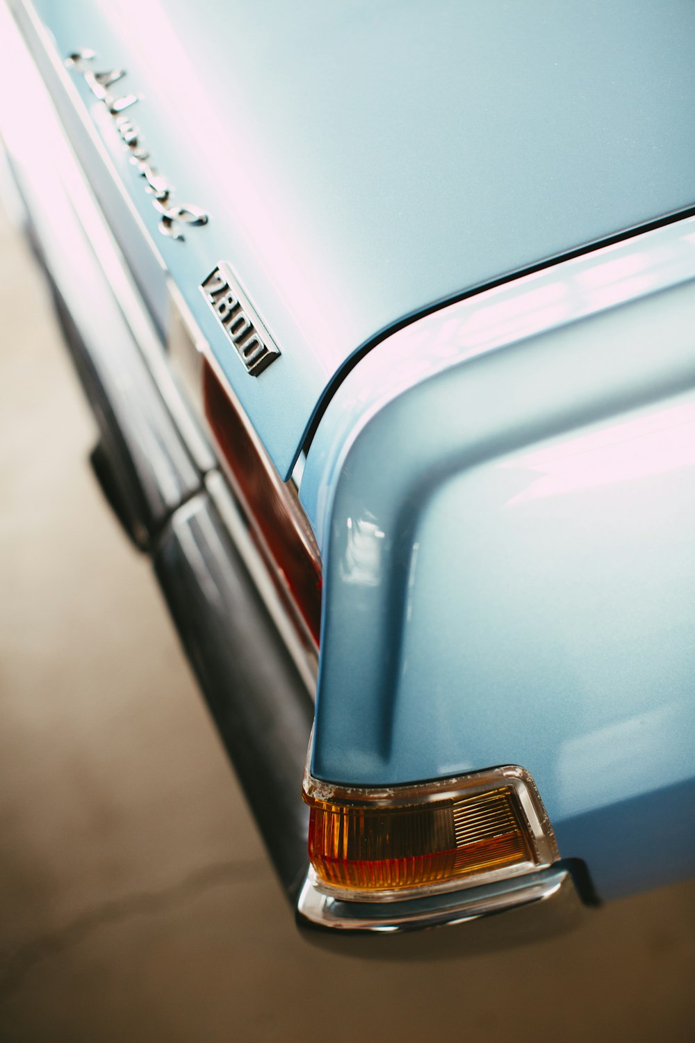 blue car with brown and black license plate