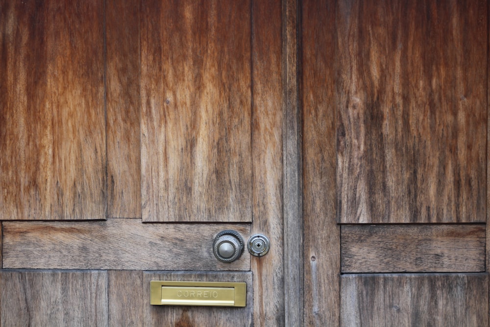 brown wooden door with silver padlock