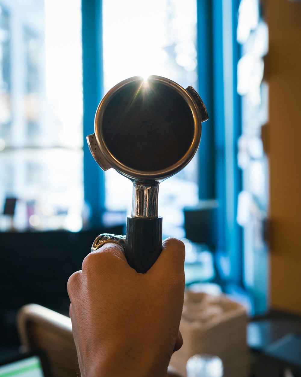 person holding black magnifying glass