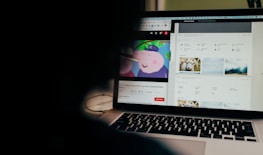 Close-up of a laptop screen showing a paused science lesson video.