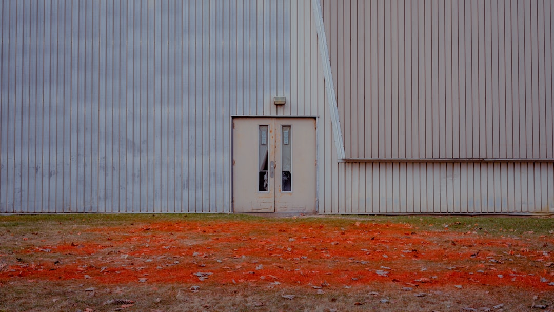 white wooden door on white steel wall