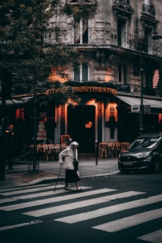 man in white jacket walking on pedestrian lane during daytime