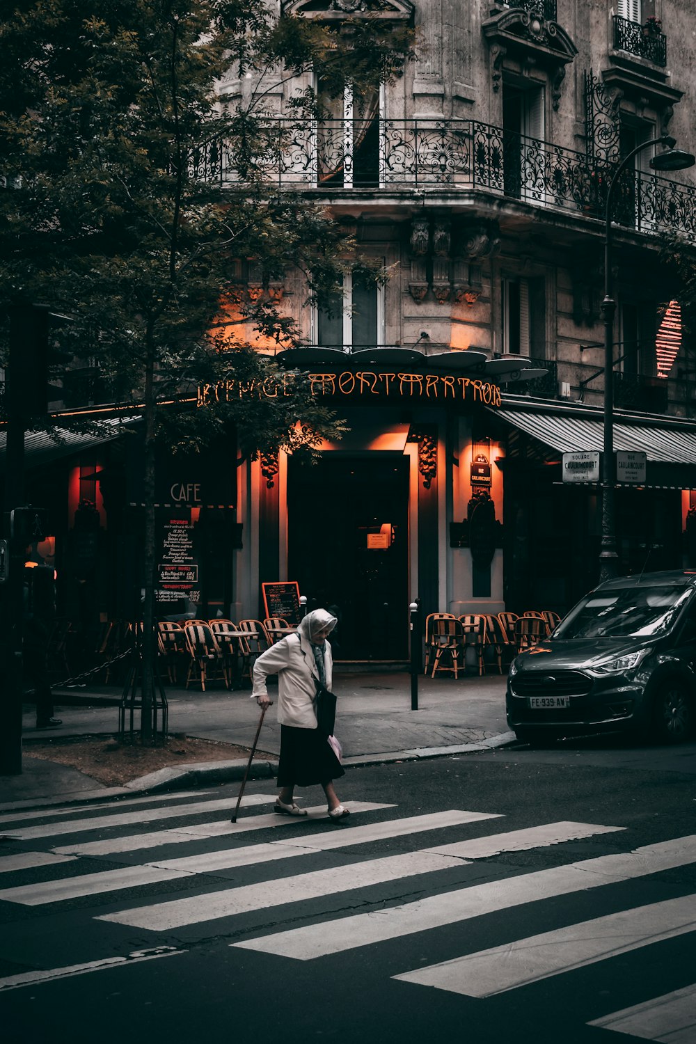 man in white jacket walking on pedestrian lane during daytime