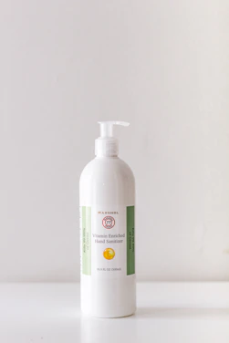 Close-up of a Sterilpro hand sanitizer bottle with fresh fruit accents in the background.