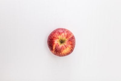 red apple fruit on white table apple teams background