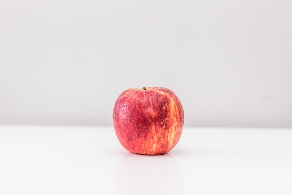 red apple on white surface