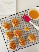 Freshly baked biscuits cooling on a rack inside a hygienic bakery section.