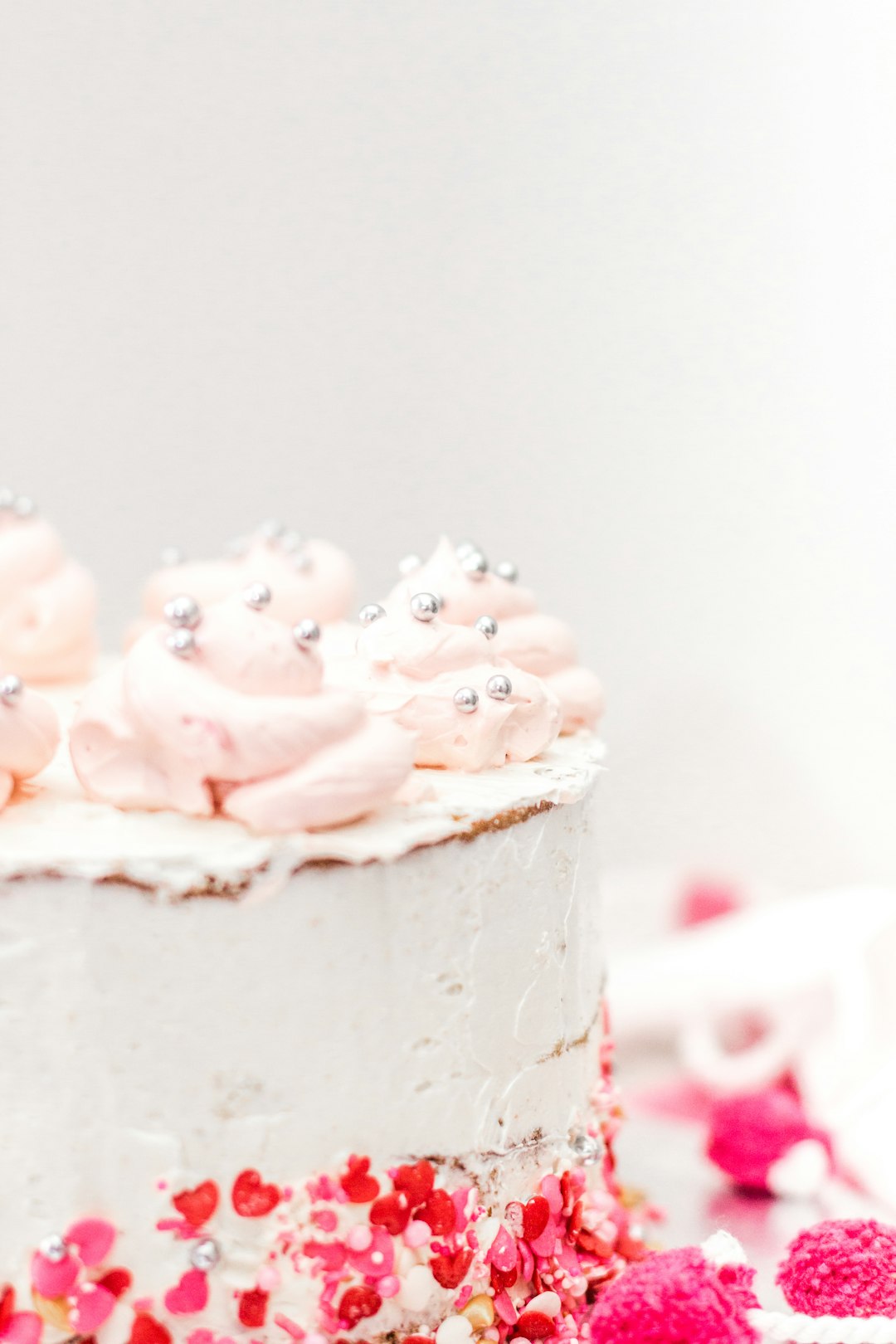 pink rose petals on white cake
