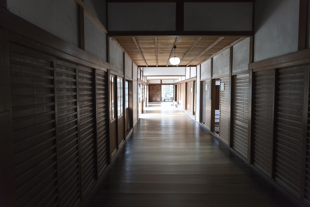 brown wooden hallway with glass windows