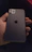 A sleek 3D hand holding a branded iPhone displaying Nexora’s unified digital inbox in dark mode.