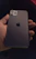 A sleek 3D hand holding a branded iPhone displaying Nexora’s unified digital inbox in dark mode.