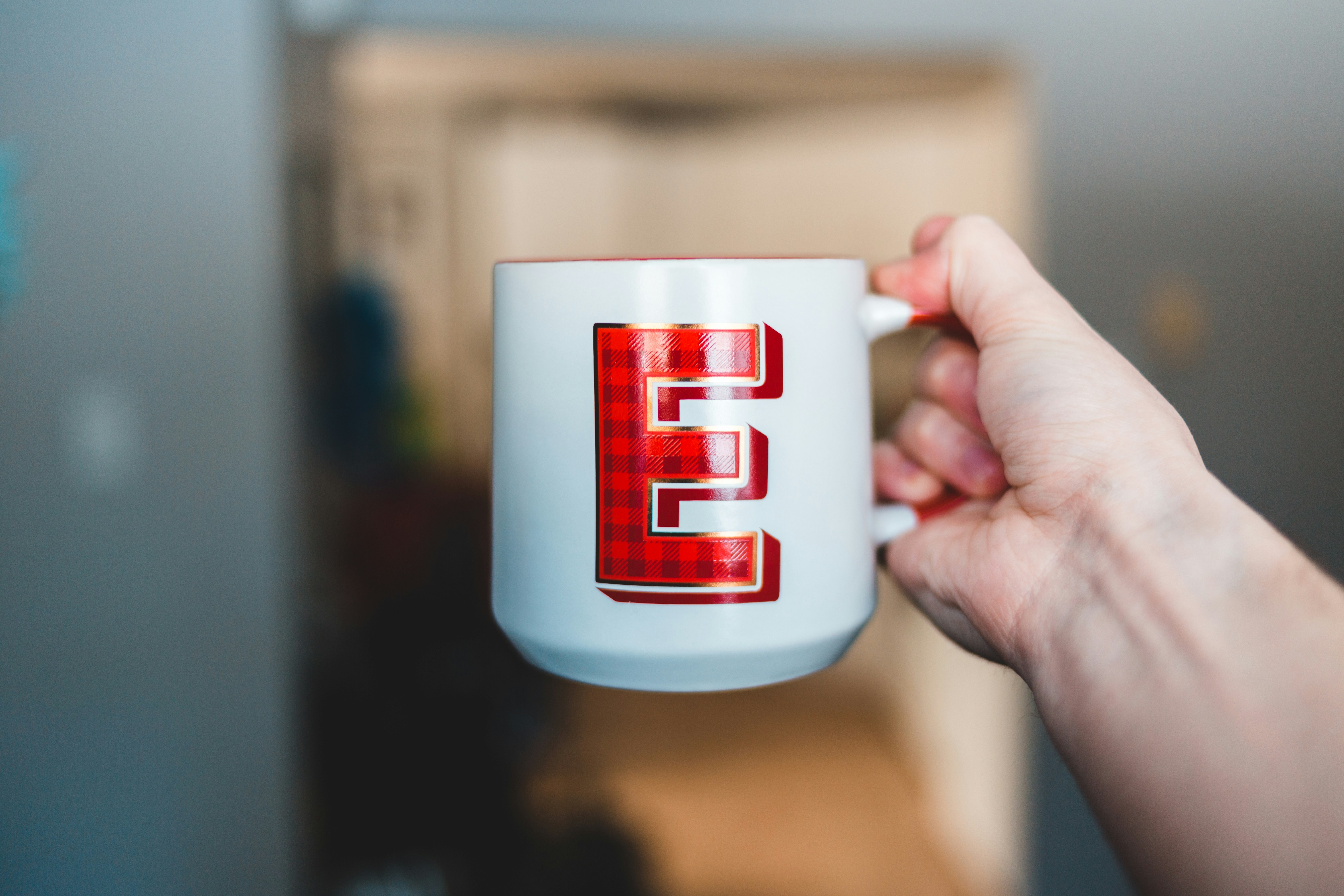 white and red ceramic mug