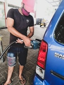 Customer filling up their car with gasoline at Gasolinera Bacum.